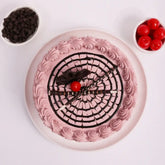 Top view of Chocolate Glory Cake - round chocolate and cherry cake with decorative swirl design, perfect for celebrations and gifting.